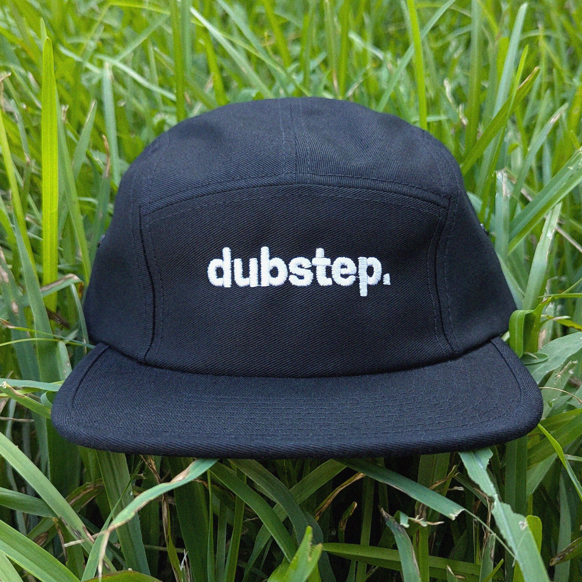 Black cap with 'dubstep.' text on grass