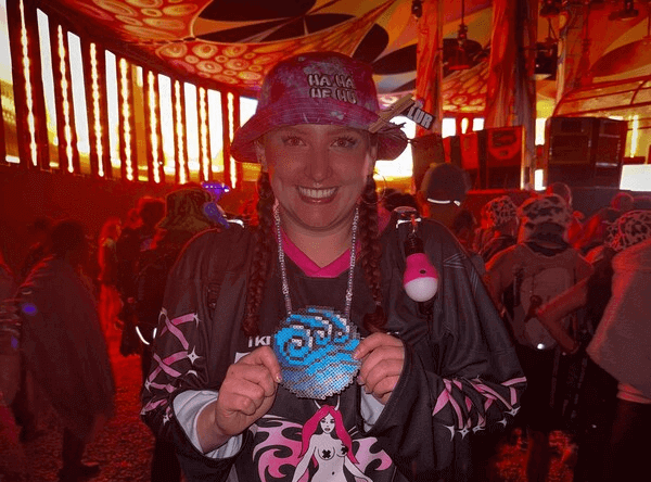 Festival bucket hat with embroidered design worn at a rave