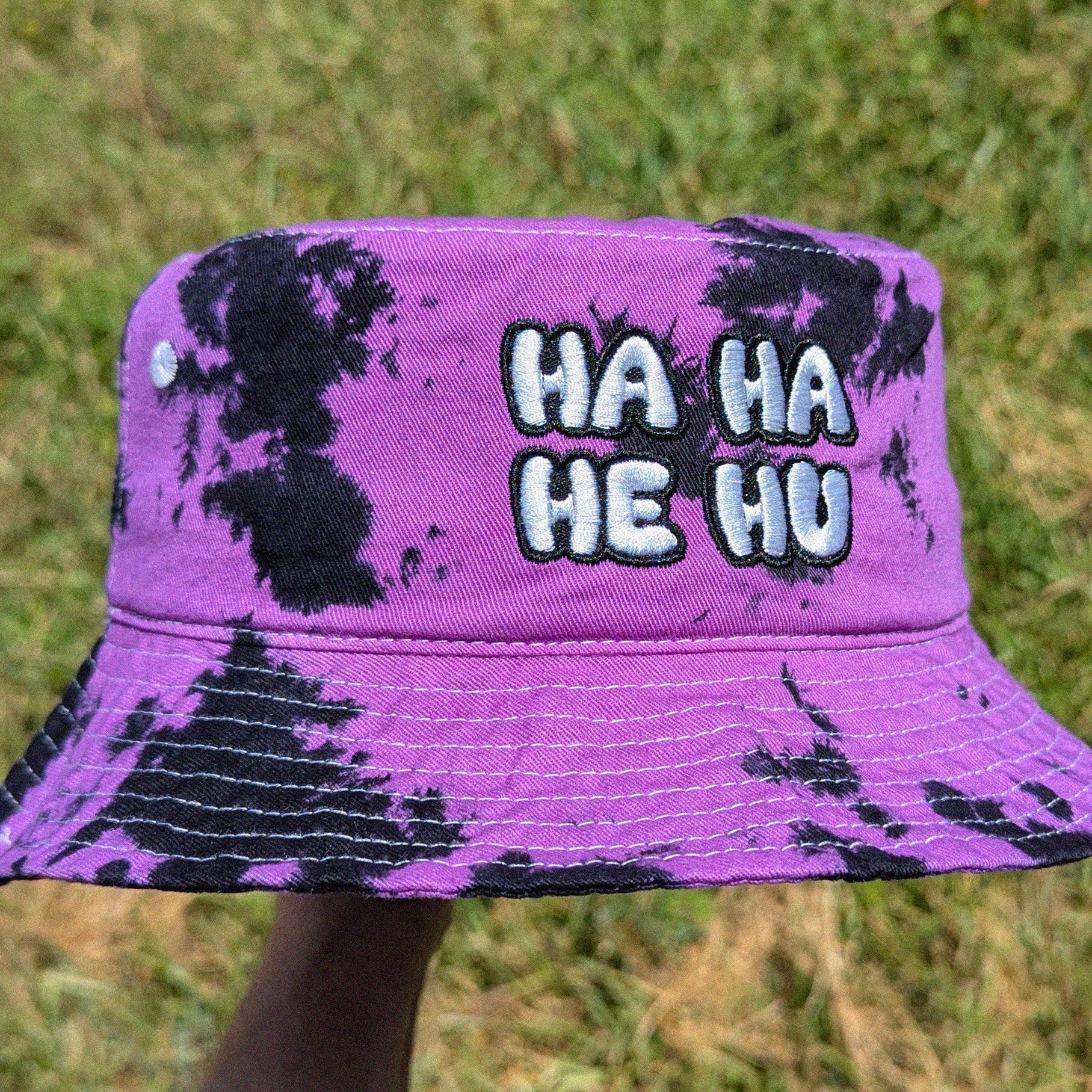 tie dye rave bucket hat with HA HA HE HU text