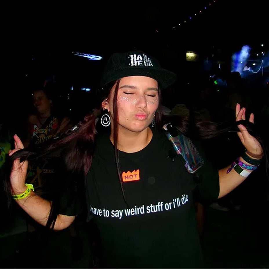 Person wearing a black 'hahahehu' cap at a rave