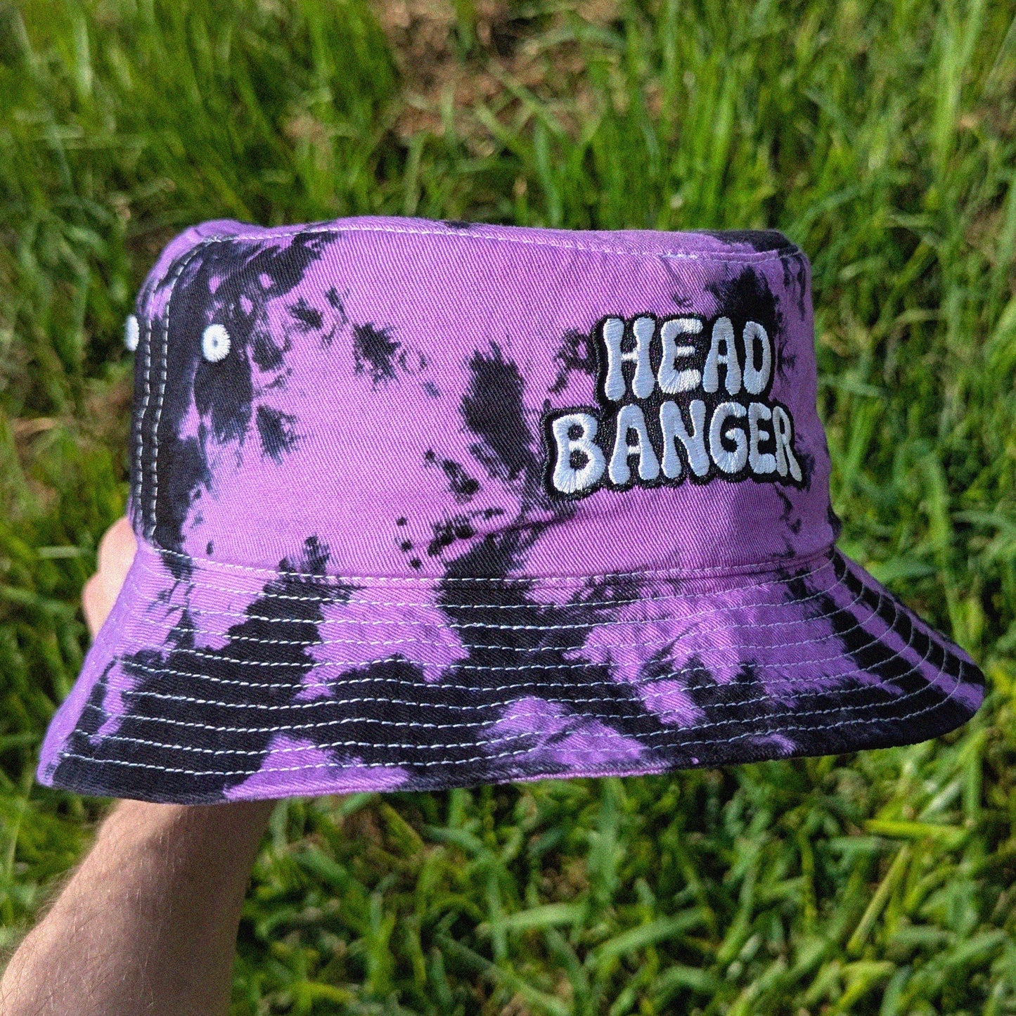 Rave bucket hat with 'HEAD BANGER' embroidered on it