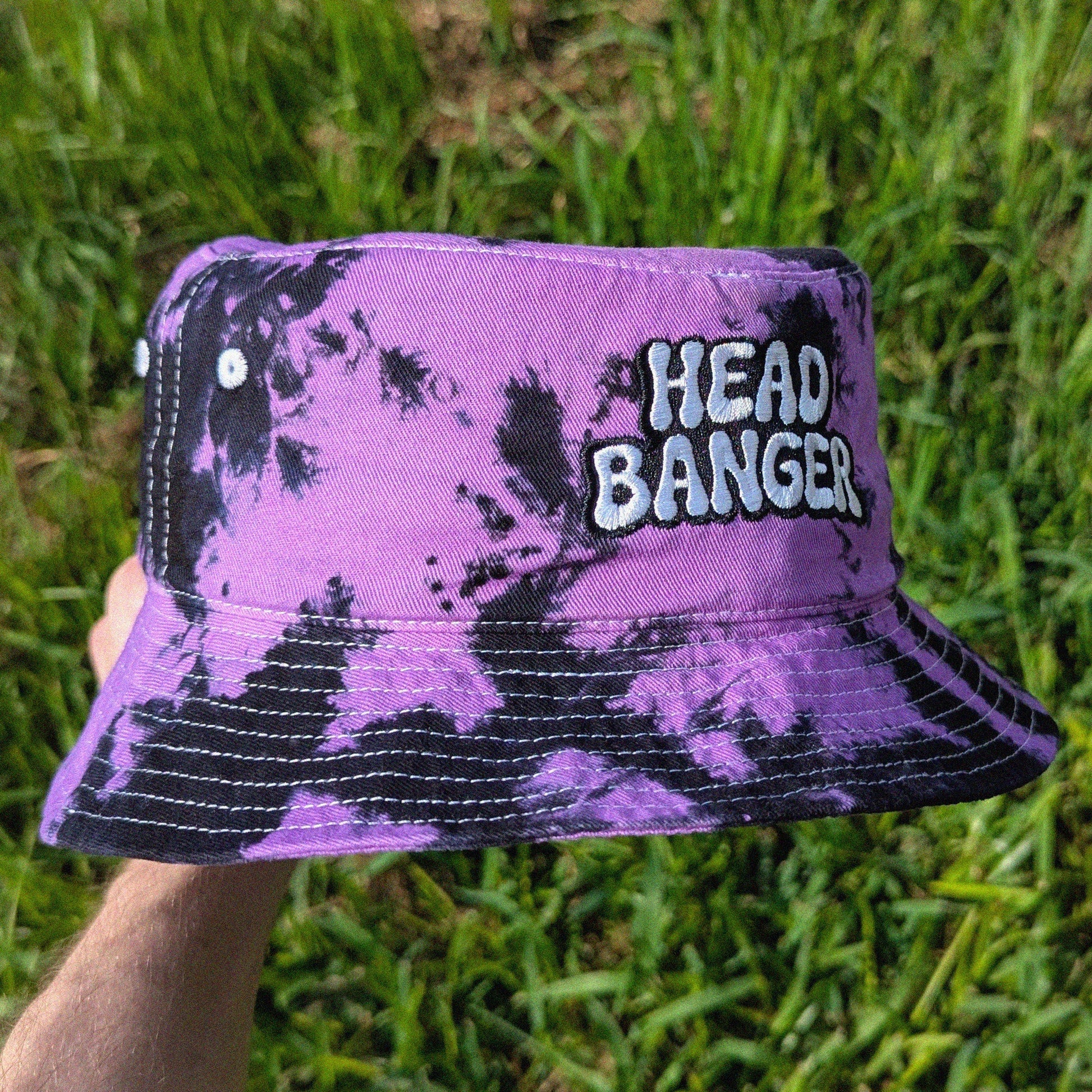 Rave bucket hat with 'HEAD BANGER' embroidered on it