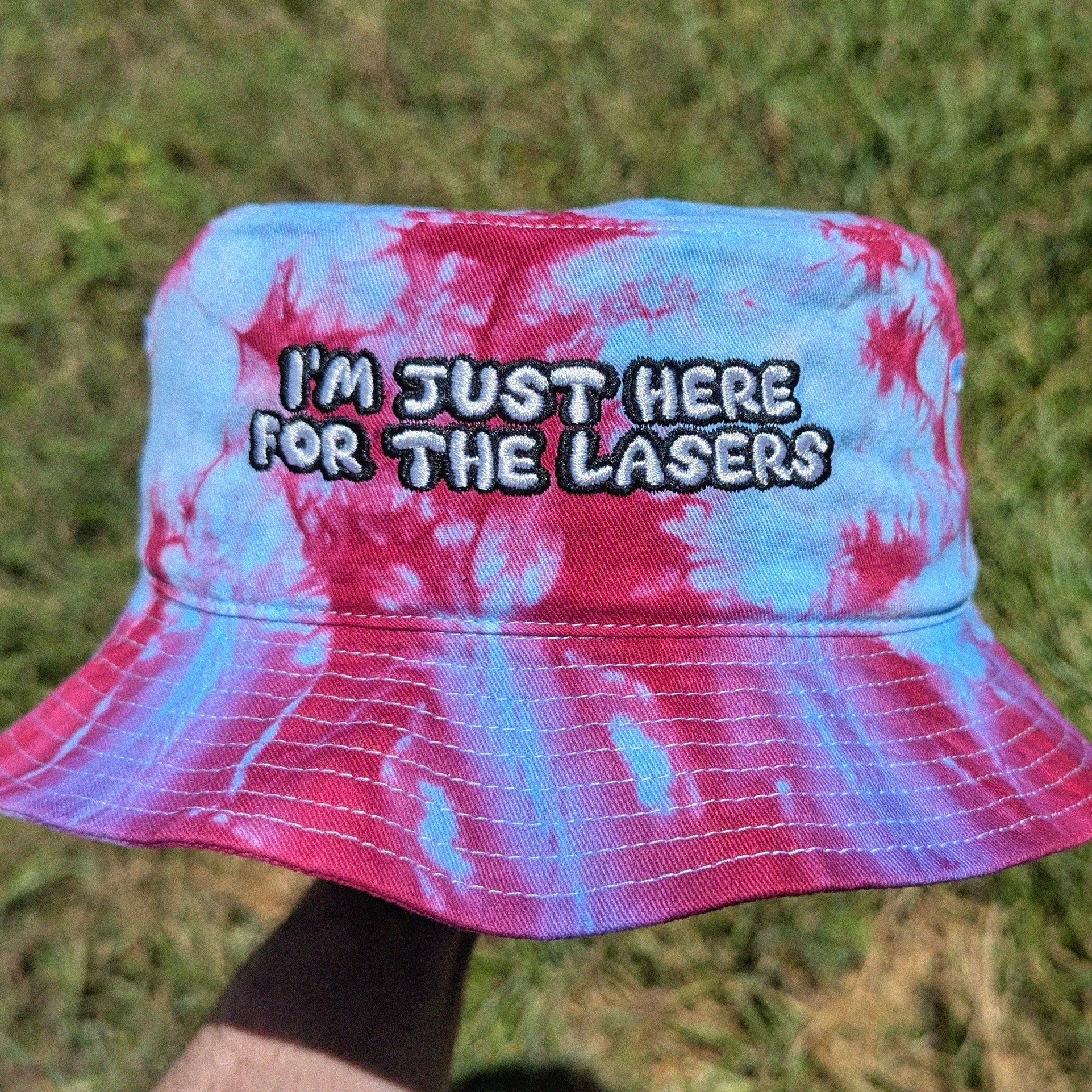 tie dye bucket hat with 'Im just here for the lasers' embroidery