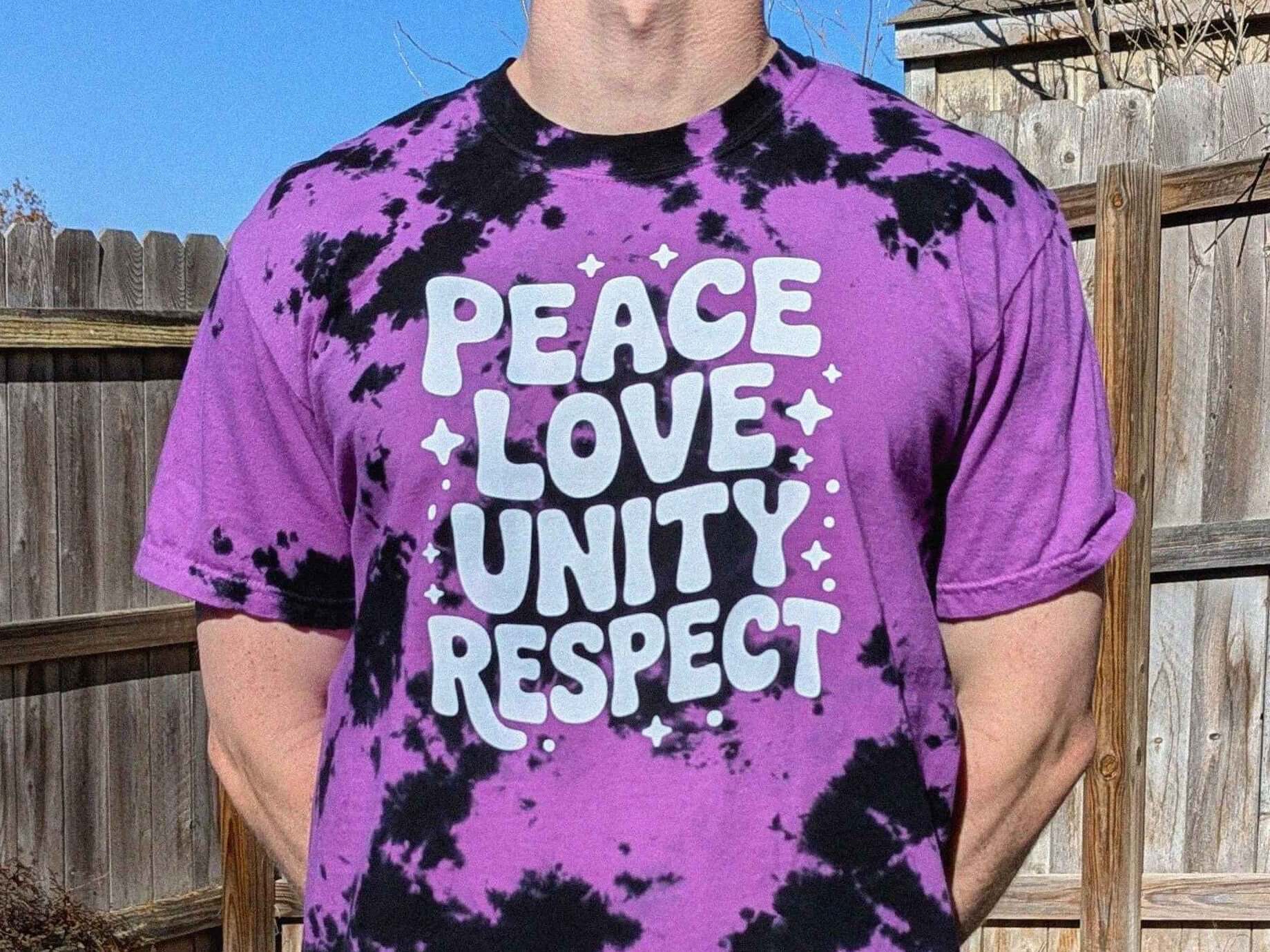 PLUR rave t-shirt in purple tie dye featuring Peace Love Unity Respect lettering, perfect EDM festival and rave outfit