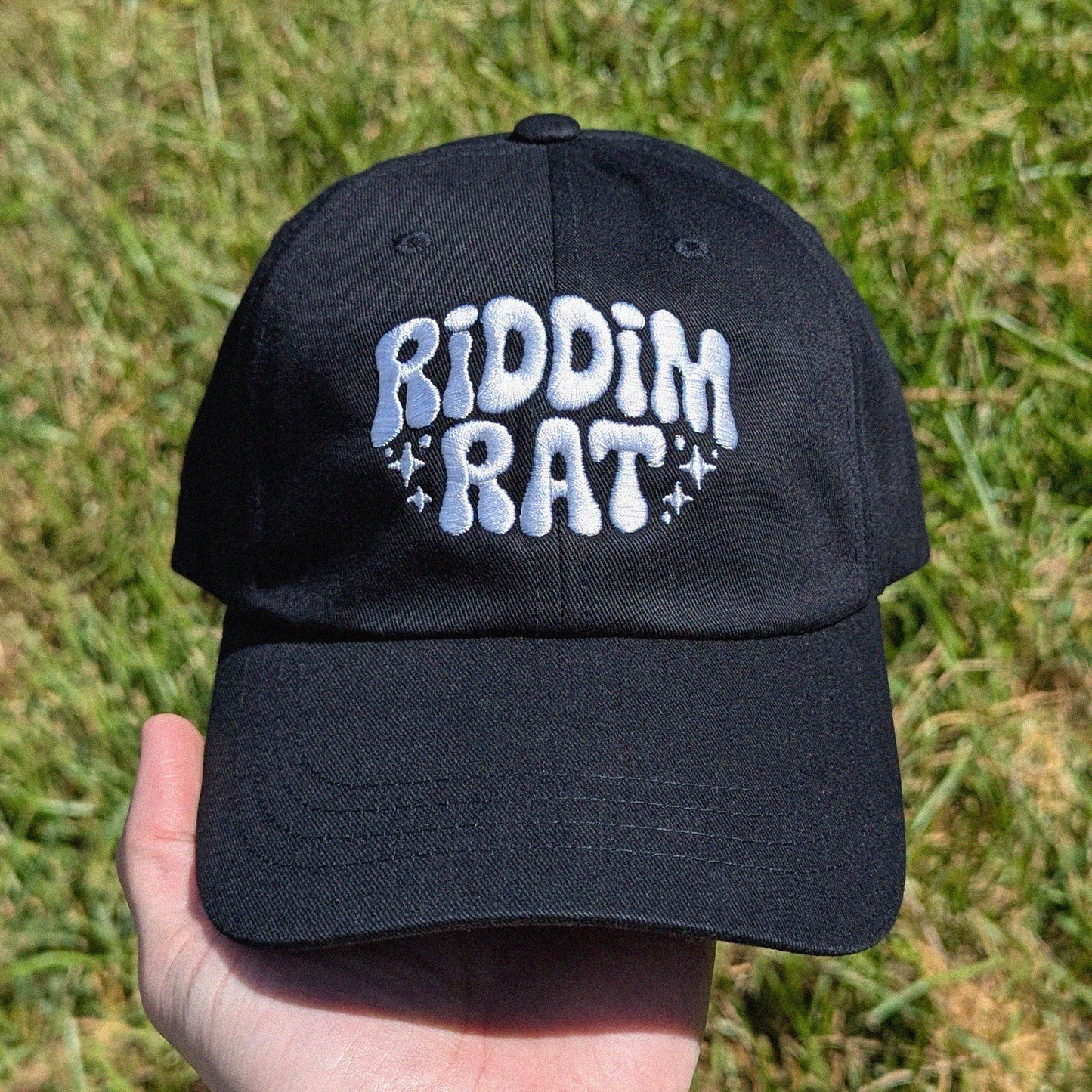 black dad hat with 'Riddim Rat' embroidered in white text