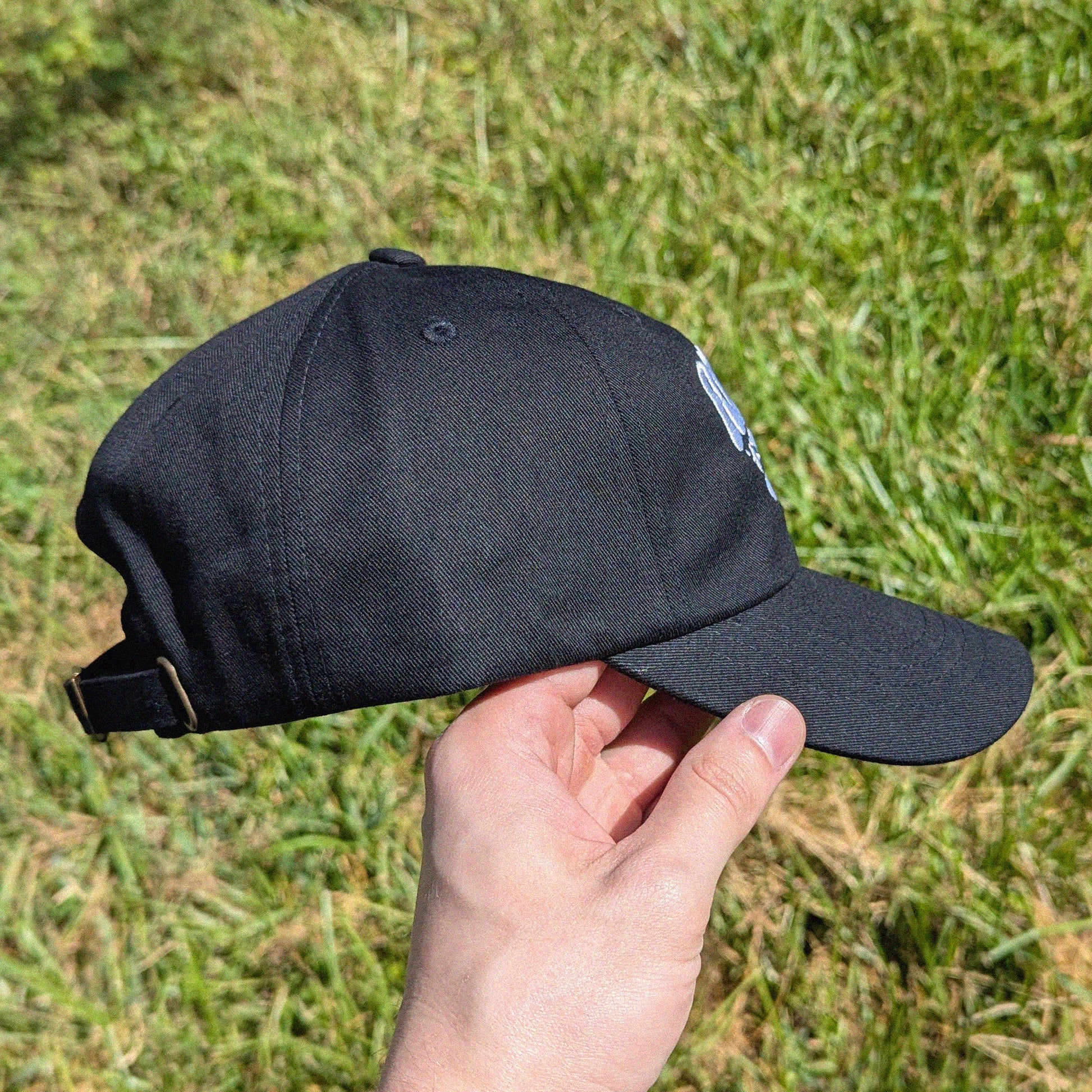 side view of rave cap that has 'Riddim Rat' embroidered on the front
