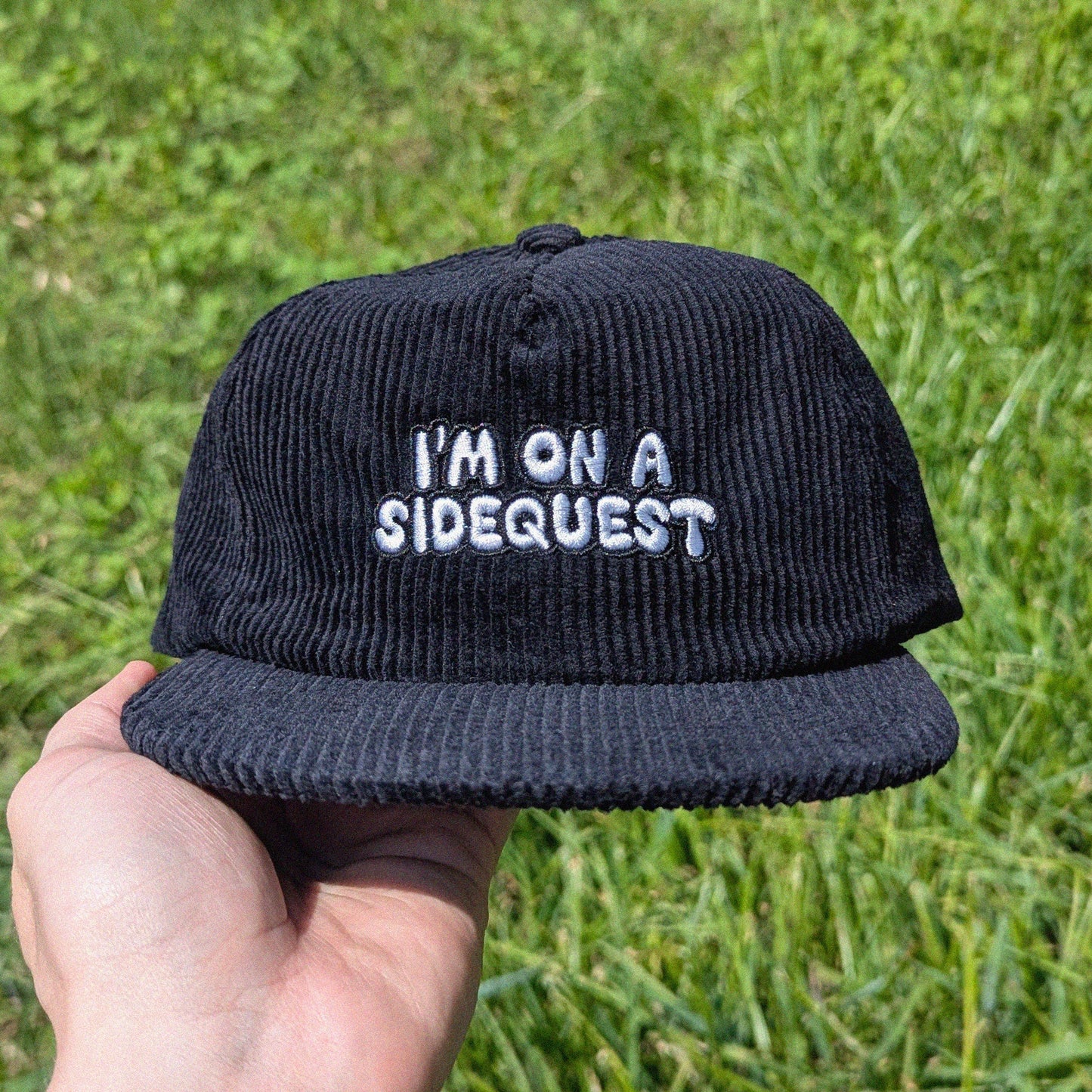 Black festival and rave corduroy cap with 'I'm on a sidequest' embroidery