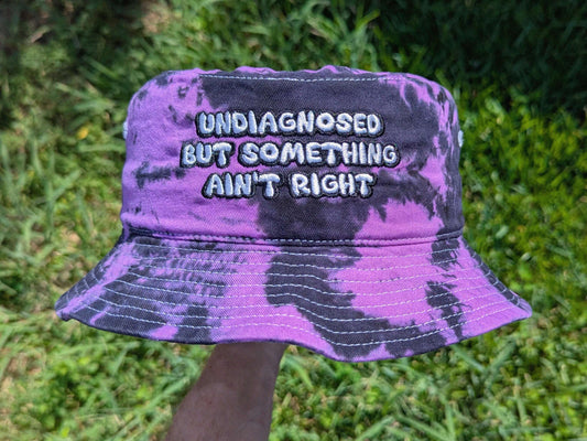 Purple and black tie dye bucket hat Undiagnosed But Something Ain't Right embroidered rave festival headwear